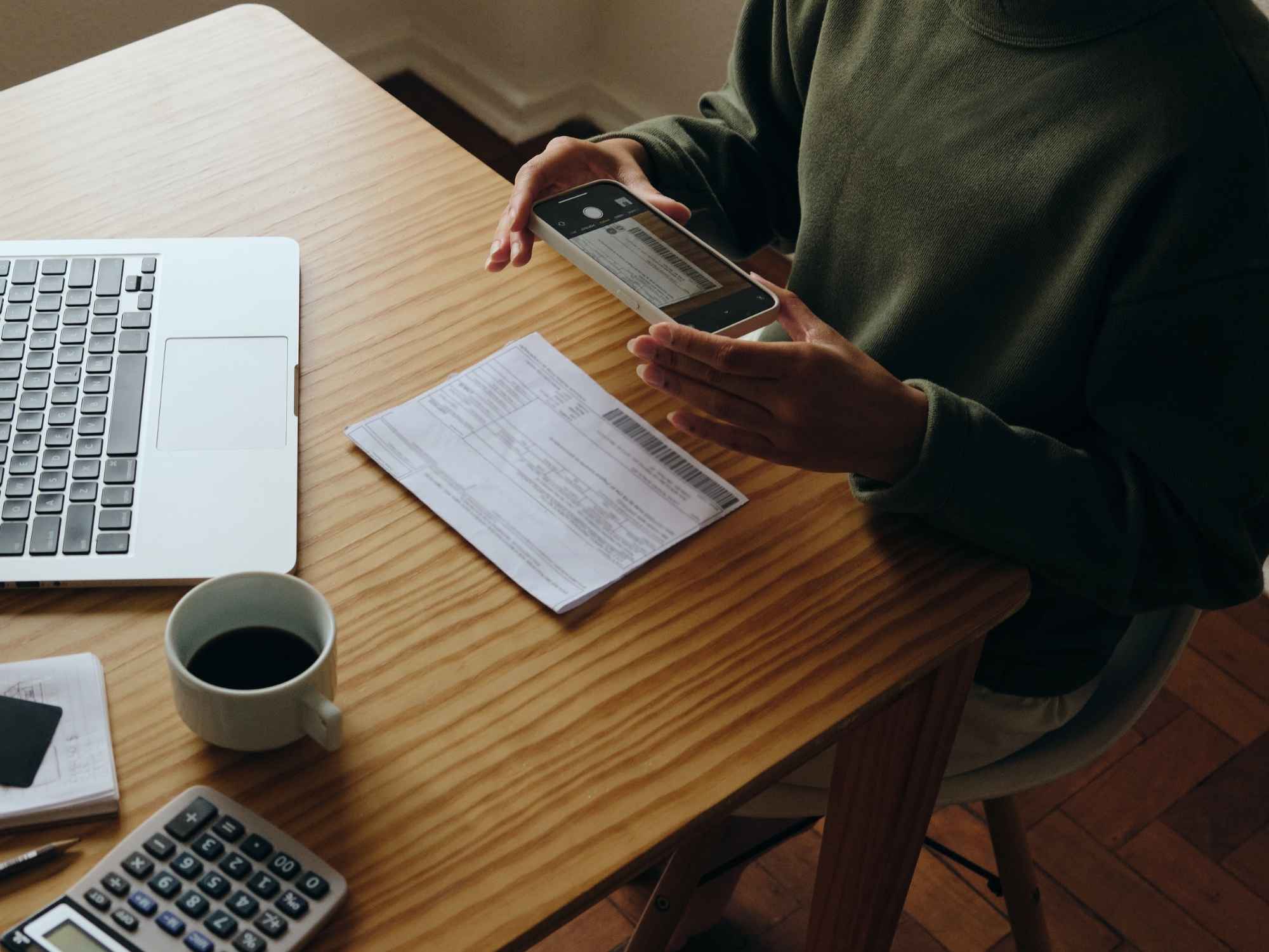 man taking picture of bond agreement with smartphone