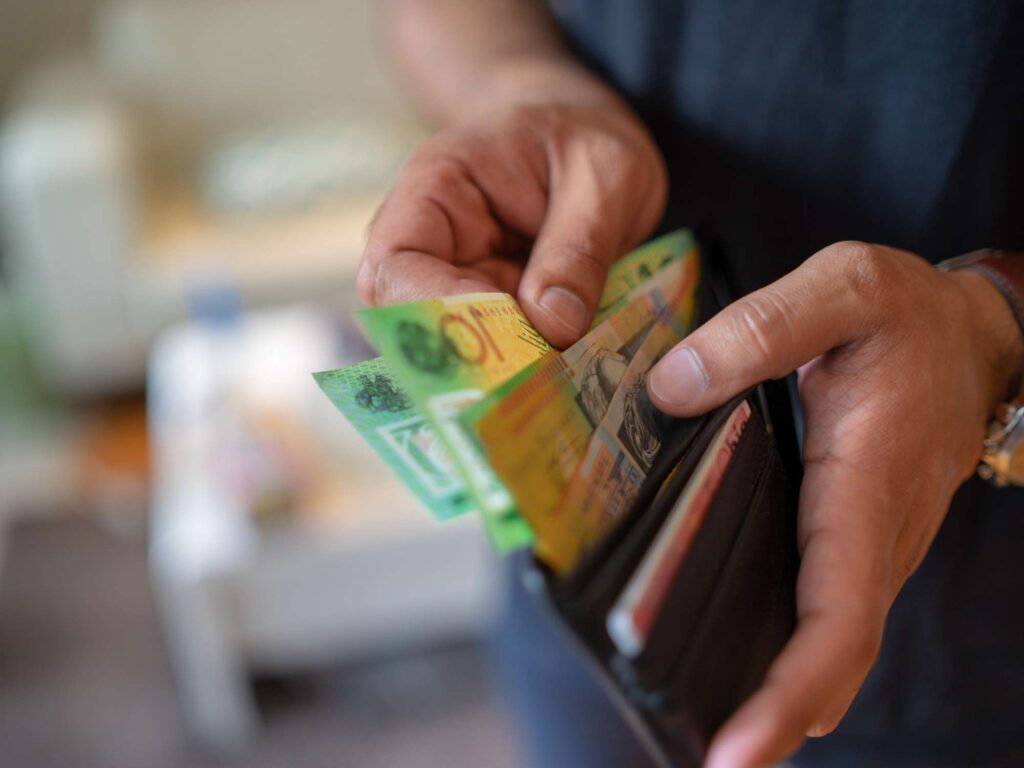 Australian dollar bills in brown wallet